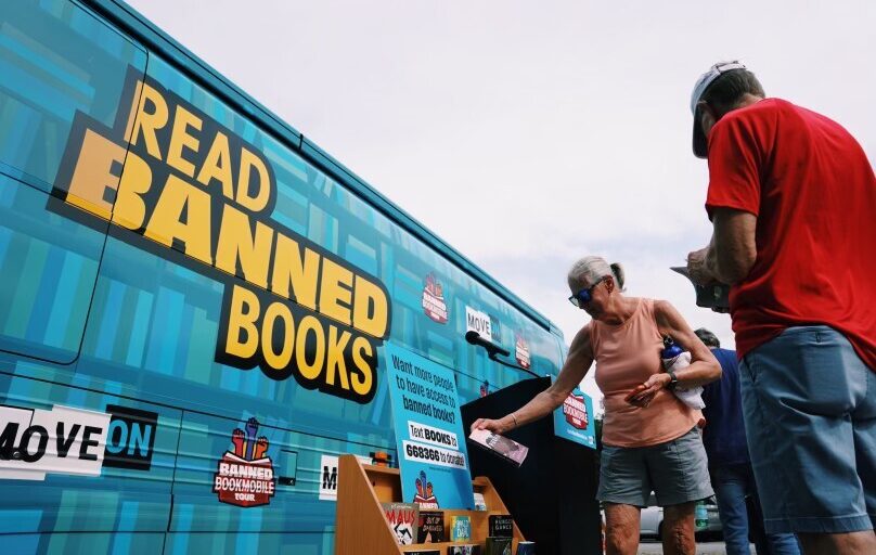 A large blue bus with the phrase, "Read Banned Books." Credit: MoveOn